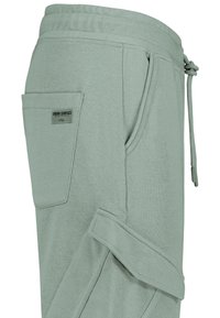 Hellgrüne Cargo-Hosen mit elastischem Bund, Kordelzug, Seitenaschen und einer aufgenähten Tasche mit dem Aufdruck "Urban Surface Organic Collection."