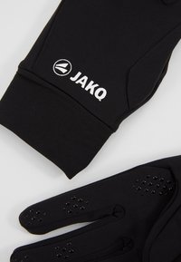 Gants de sport noirs avec des grips texturés sur les doigts, arborant un logo JAKO en blanc. Fabriqués dans un matériau flexible et lisse.
