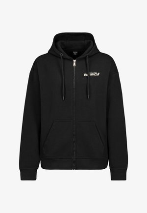 Black zip-up hoodie made of cotton. Features double drawstrings, a front pocket, and "LOW IMPACT" printed in white on the chest.
