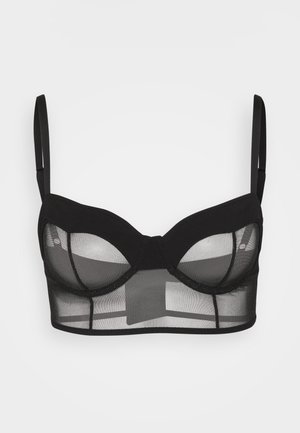 Zwarte onderwired bra met doorzichtige mesh en stevige stof. Beschikt over verstelbare banden, een gestructureerd ontwerp en een platte band voor ondersteuning.