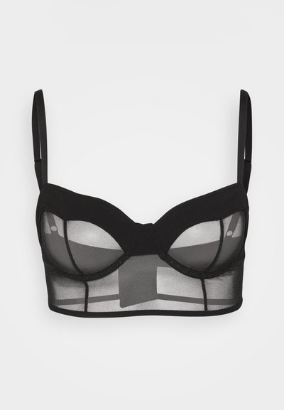Zwarte onderwired bra met doorzichtige mesh en stevige stof. Beschikt over verstelbare banden, een gestructureerd ontwerp en een platte band voor ondersteuning.