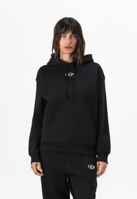 Black hoodie in soft fabric with a drawstring and logo detail on the chest. Features a relaxed fit and ribbed cuffs and hem.
