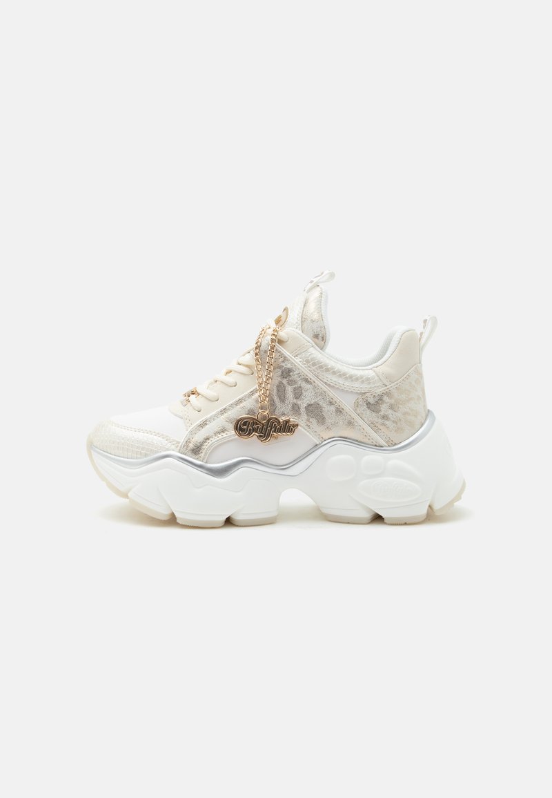 Άσπρο chunky sneaker με λεπτομέρειες λεοπάρ, χοντρή σκαλιστή σόλα και χρυσό charm "Buffalo" στα κορδόνια σε απλό φωτεινό φόντο.