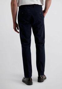 Marineblaue Chinos mit geradem Schnitt, aus einem glatten Stoff gefertigt. Verfügt über zwei Gesäßtaschen mit Knöpfen und ein minimales Taillendesign.