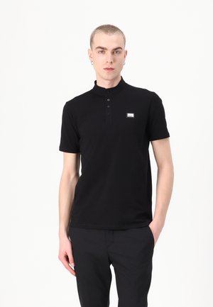 Black polo shirt with a high collar, short sleeves, and a button placket. Features a small logo patch on the left chest. Soft, smooth texture.