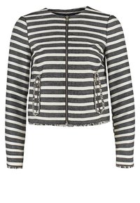 Paskiowana kurtka w czarno-białe pasy, teksturowana tkanina, zapięcie na zamek, dwie przednie kieszenie z frędzlami oraz okrągły dekolt.