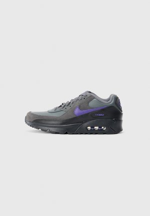 Low-top Nike Air Max sneaker in grey, black, and purple with visible air cushion in sole, displayed on a white background.