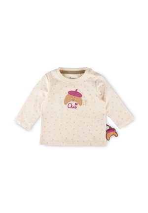 Maglietta a maniche lunghe per bebè color crema con piccoli puntini rosa, personaggio croissant con berretto rosa e la parola "Oui" ricamata sul davanti.