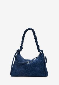 Navy blue suede handbag with a scrunched shoulder strap, floral embossed design, and silver-tone hardware. Features adjustable side strap.