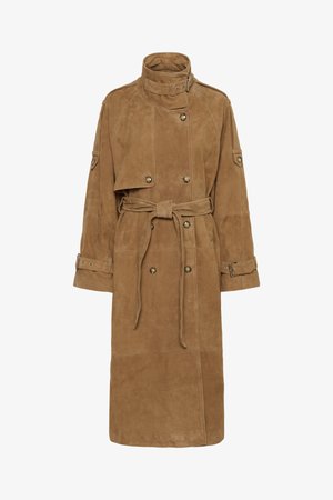 Tan suede trench coat with a high collar, double-breasted front, belted waist, and large pockets. Features cuff straps and a textured finish.