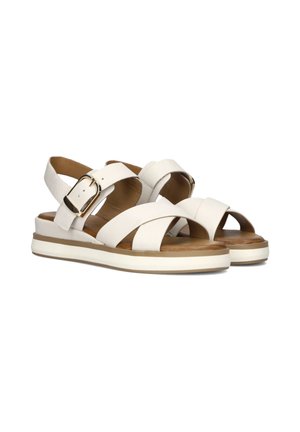Witte leren sandalen met kruislingse banden en een achterste gesp. Dikke witte zool met een tan kleurige voetbed. Open teenontwerp.