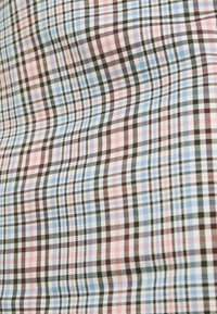 Plaid fabric featuring a blue, pink, and brown color scheme. The pattern consists of intersecting lines in varying widths.