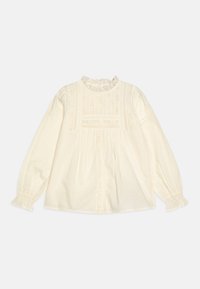 Blusa color crema con maniche lunghe, dettagli in pizzo, plissee e scollatura arricciata. Presenta una vestibilità morbida e una texture del tessuto delicata.