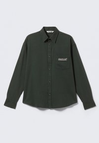 Dark green long-sleeve button-up shirt with collar and chest pocket labeled "ATHLETIX DEPT" on a plain light background.