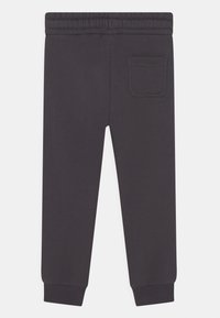 Mørkegrå sweatpants med elastisk talje, ribbede mansjetter og en enkelt baglomme. Fremstillet af et blødt, glat stof.