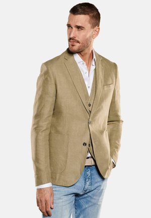 Beige linen blazer with light texture, single-breasted design, two front pockets, and metal buttons, layered over a white shirt and waistcoat.