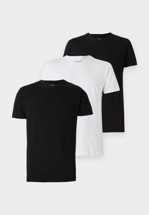 Three crew neck t-shirts in black, white, and dark gray. Made from cotton, they have short sleeves and a standard fit.