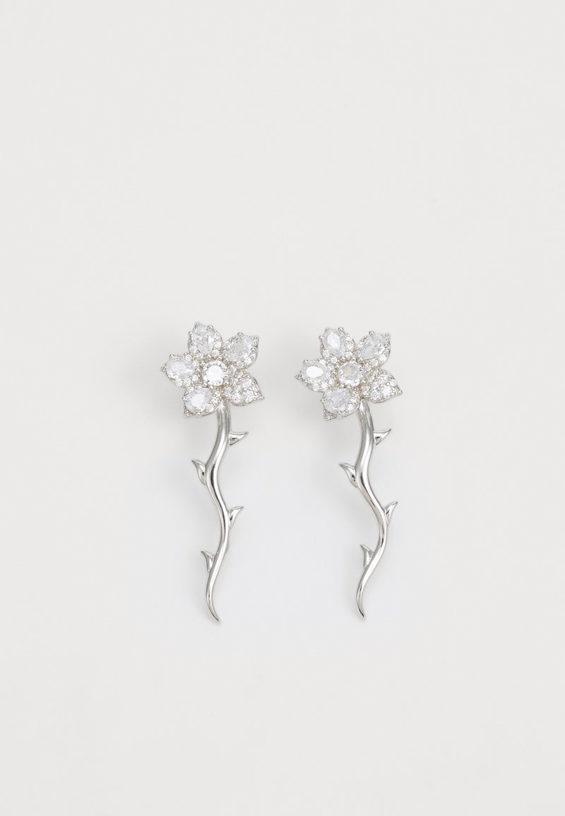 Silverörhängen designade som blommor med en stam. Har klara, oval-slipade stenar och en texturerad, bladlik detalj längs stammen.