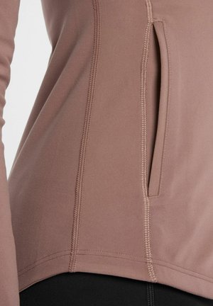 Licht mauve sporttop gemaakt van rekbaar stof, met een zijzak, platte naden en een gebogen zoom voor gemakkelijke beweging.