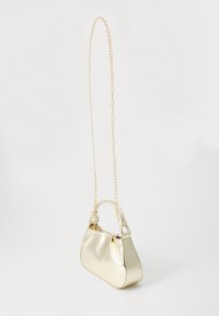 Metallic gold handbag with a smooth texture, a curved shape, and short handles. Features a gold chain strap and no visible patterns.