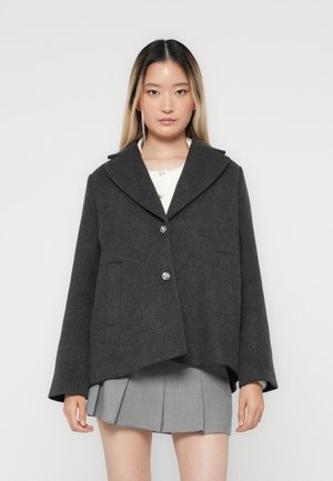 Gray wool blend jacket with a large collar, two front pockets, and round silver buttons. Features a relaxed fit and smooth texture.