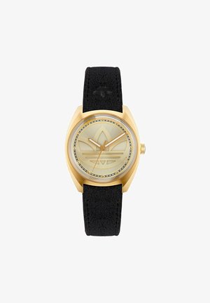 Goldfarbene Uhr mit einem strukturierten schwarzen Armband, rundem Zifferblatt und einem gravierten Logodesign auf einem hellgoldenen Ziffernblatt. Verfügt über ein klares, schützendes Glas.