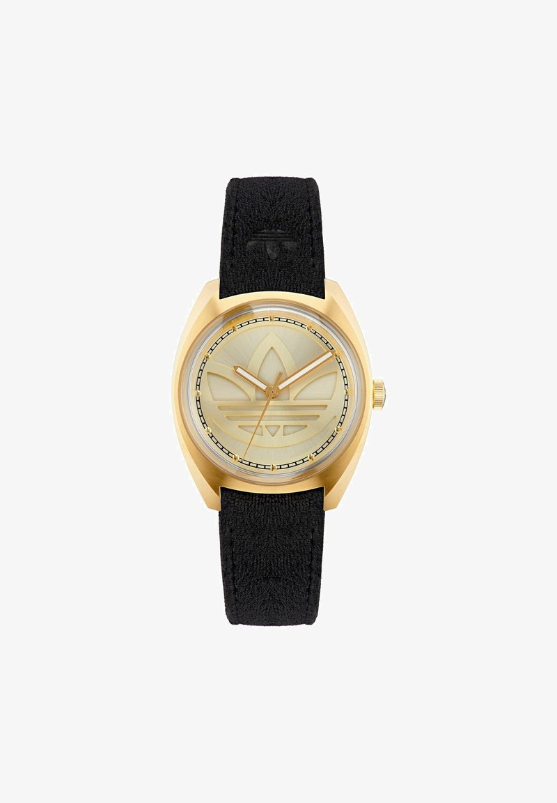 Goldfarbene Uhr mit einem strukturierten schwarzen Armband, rundem Zifferblatt und einem gravierten Logodesign auf einem hellgoldenen Ziffernblatt. Verfügt über ein klares, schützendes Glas.