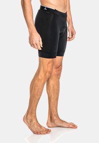 Pantalones cortos deportivos negros con un diseño ajustado, que cuentan con un panel lateral texturizado, cinturilla elástica y costuras reforzadas.