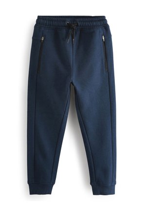 Pantalon de jogging bleu marine avec taille élastique, cordon noir, poches latérales zippées et poignets côtelés aux chevilles.