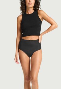 Top court noir sans manches avec un col haut, associé à un bas de bikini noir taille haute. Texture lisse, ajusté au corps.