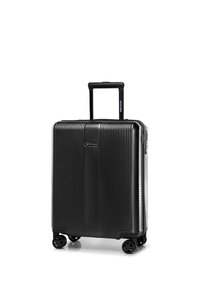 Black hard-shell suitcase with vertical ridges, four spinner wheels, and an extended telescopic handle.