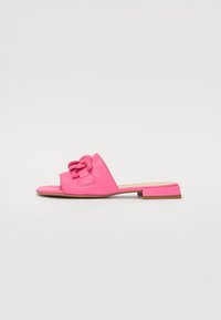 Pink slide sandal featuring a knotted accent, open toe design, low block heel, and smooth synthetic material.