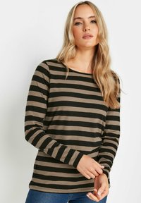 Långärmad skjorta i svart och beige, med horisontella ränder och rundad halsringning, tillverkad av mjukt bomullstyg.