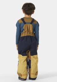 Mono aislante en azul marino y beige con correas ajustables, cintura elástica y ajustes de velcro en los tobillos para mayor flexibilidad y comodidad.
