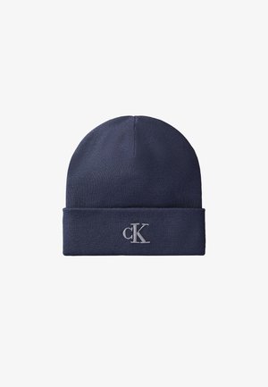 Bonnet en maille bleu foncé avec revers replié brodé du logo "cK" gris clair au centre devant.