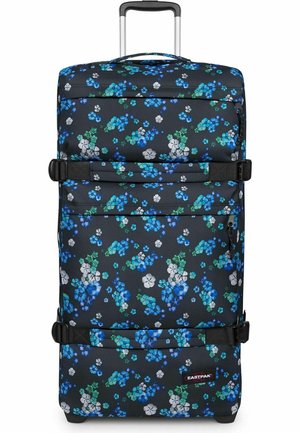 Valise roulante noire avec motif floral bleu, blanc et vert, deux sangles réglables, poche avant zippée et poignée télescopique étendue.