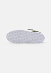 Grønn semsket sneaker med hvit gummisåle som har et diamantmønster. Enkel design med minimale detaljer og uten synlig merkevare.