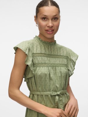 Green patterned dress with ruffled sleeves, front tie belt, and delicate detailing on the bodice. Lightweight fabric with a textured finish.