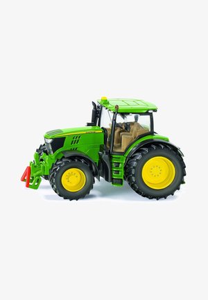Green tractor with yellow accents, large black tires, detailed cab with beige interior, and prominent front hardware. Notable color contrasts.