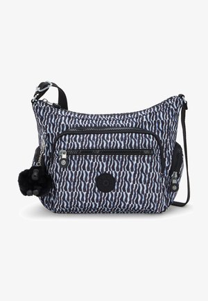 Tasche mit Zebra-Muster in blau und schwarzem Stoff, ausgestattet mit mehreren Reißverschlusstaschen und einem Pompon-Accessoire. Strukturierte Oberfläche.
