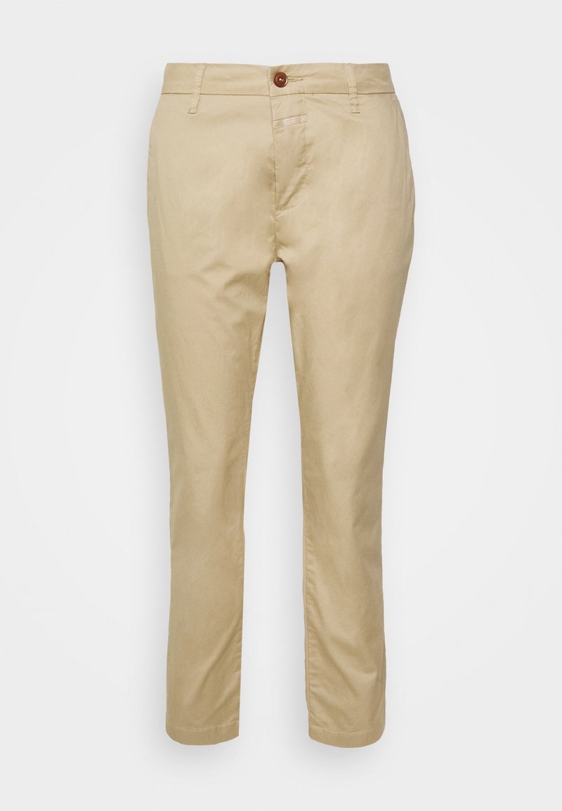 Beżowe spodnie chinos z zapięciem na guziki, szlufkami na pasek i przednimi kieszeniami. Gładka bawełniana tkanina, zwężany krój i przeszywany dół.