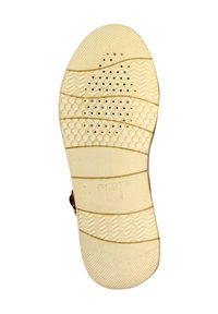 Semelle de chaussure couleur crème avec des motifs texturés, comprenant des lignes ondulées et des formes hexagonales. Présente des trous de ventilation pour une meilleure respirabilité.