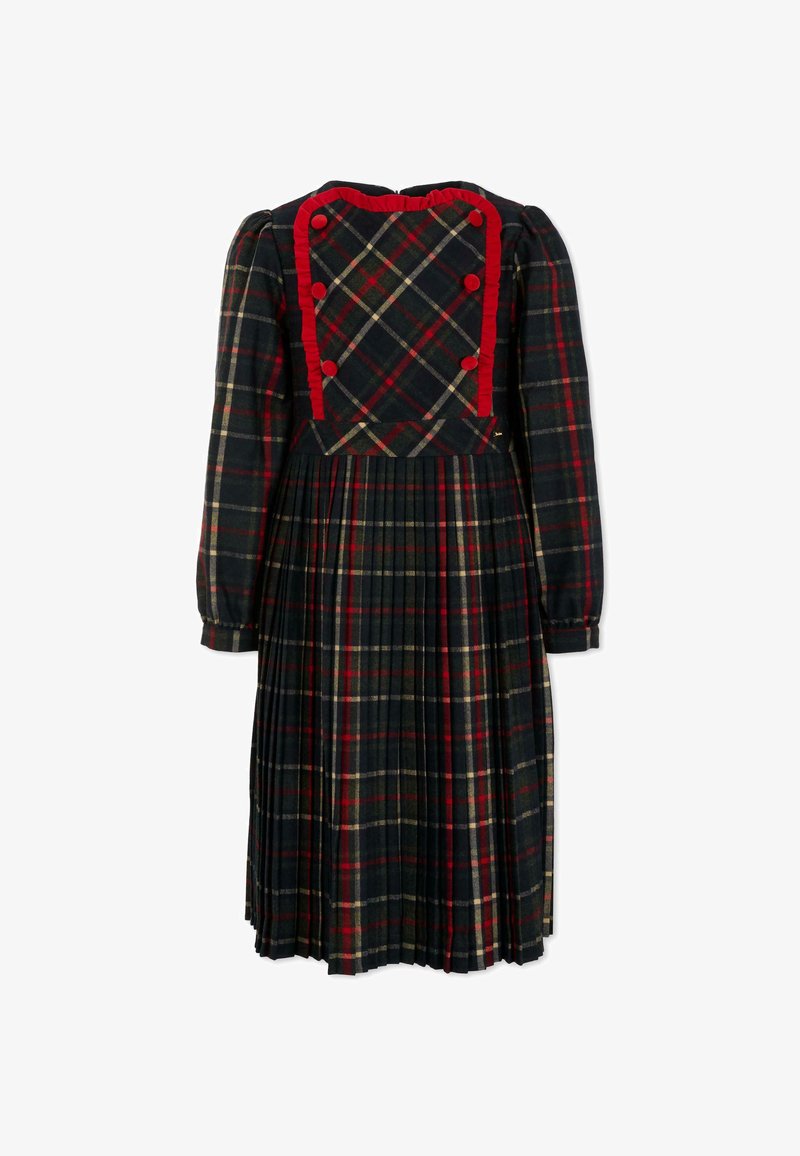 Sukienka w kratę w kolorach zielonym, czerwonym i kremowym. Posiada plisowaną spódnicę, długie rękawy oraz falbaniasty dekolt z czerwonymi guzikami.