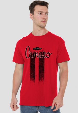 Red cotton t-shirt featuring a black graphic of "Camaro" and two vertical stripes, with Chevrolet logo above. Short sleeves, crew neck design.