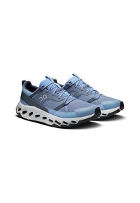 Running shoes with a blue and gray color scheme. Mesh upper, round toe, and cushioned white midsole with cut-out details.