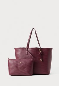 Burgundy faux leather tote bag with woven texture and smooth finish, featuring a detachable matching pouch with zip closure and logo detail.