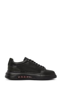 Sneaker nere in pelle con una finitura liscia, design con lacci e una suola ammortizzata che presenta una tasca d'aria visibile con un interno a motivi.