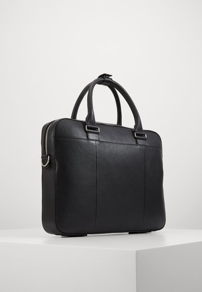 Black leather laptop bag with dual handles, textured surface, and silver-tone hardware. Features a sleek rectangular shape and zip closure.