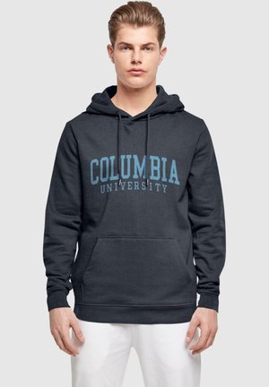 Dark gray hoodie made of cotton, featuring a kangaroo pocket and drawstring hood. "Columbia University" printed in light blue on the front.