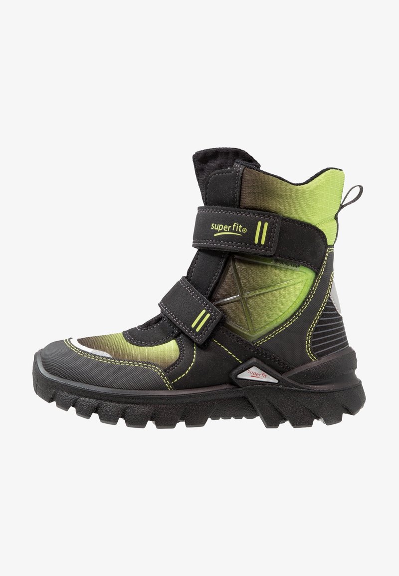 Botte d'hiver montante pour enfant en noir et vert avec deux bandes Velcro, semelle robuste et languette à l'arrière.